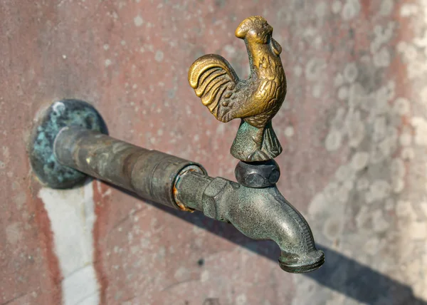 Vintage faucet with rooster.Bronze Water tap with rooster outside on the wall.