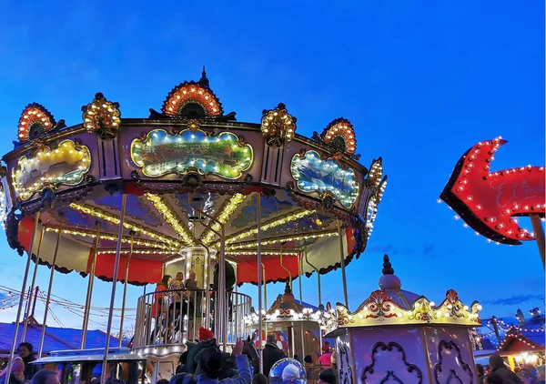 Christmas market, fair and colourful carousel in the old town for christmas. — Stock Photo, Image