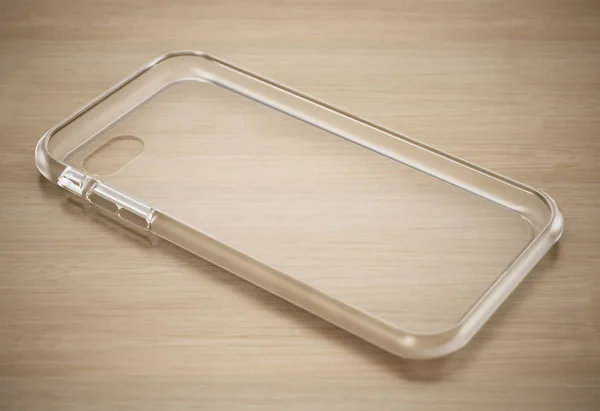 Transparent silicone smartphone cover standing on wooden surface. 3D illustration — Stock Photo, Image