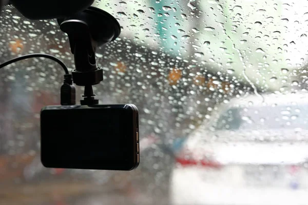small video camera record inside motor vehicle on windshield, drive car road trips in rainny day weather