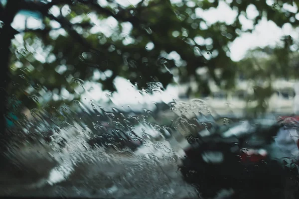 Kropla deszczu wody na przedniej szybie samochodu jazdy na drogach — Zdjęcie stockowe