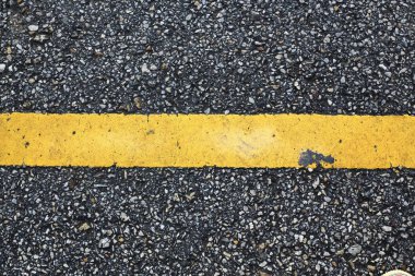 yellow line marking on black asphalt road