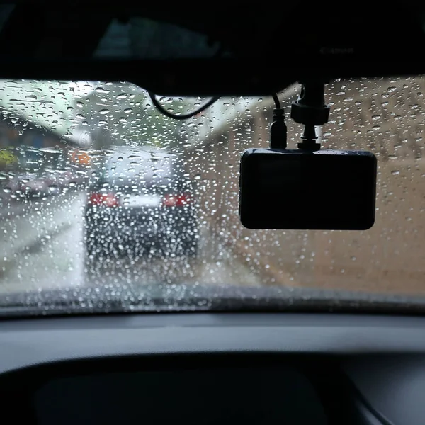 small video camera record inside motor vehicle on windshield, drive car road trips in rainny day weather