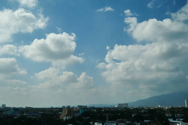 Beyaz bulut açık mavi gökyüzü üzerinde şehrin ufuk çizgisi — Stok fotoğraf