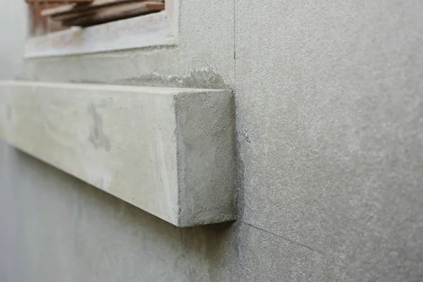 Window frame on cement wall inside construction site building — Stok fotoğraf