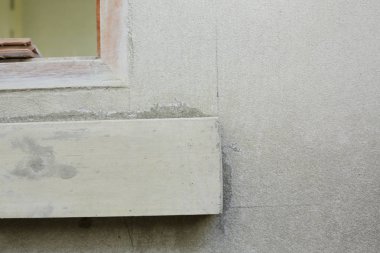 window frame on cement wall inside construction site building