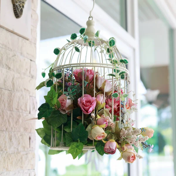 Rose flower in cage hanging decoration in front of cafe — Stock Photo, Image