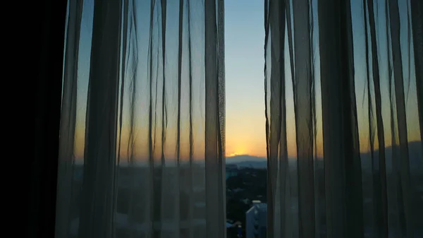 sunlight through white curtain with sunset sky view outside