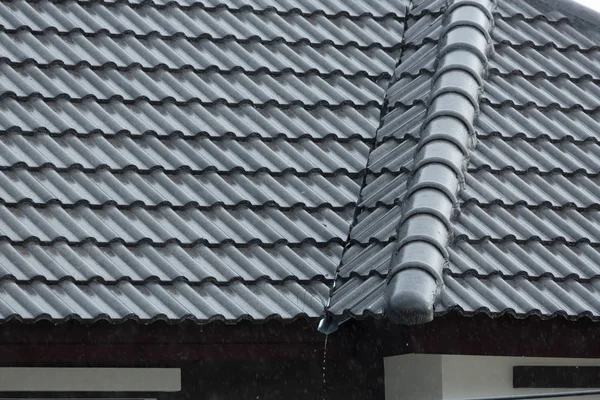 Βροχή θύελλα κάτω χύστε σε μαύρο κεραμίδι στέγη της οικιστικής κατοικίας — Φωτογραφία Αρχείου