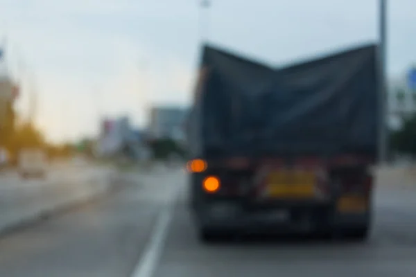 truck driving on urban road, image blur background