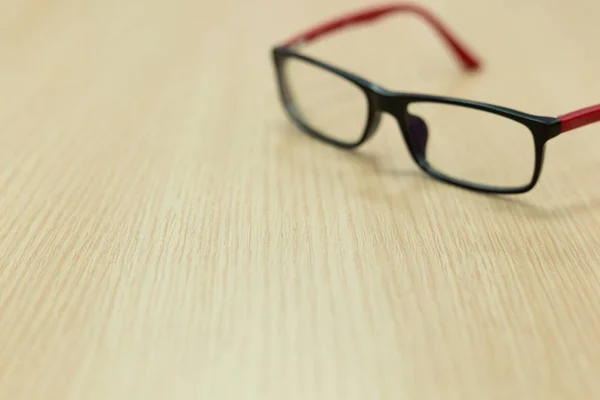 Eyeglasses on wooden table office — Stock Photo, Image