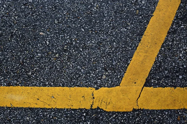 Yellow line marking on black asphalt road — 스톡 사진