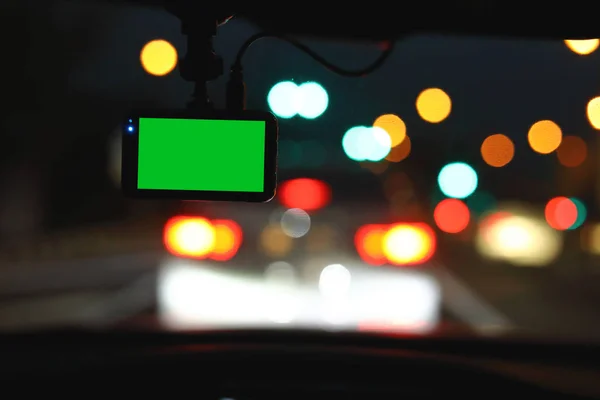 blank green screen video camera recorder in car driving on night