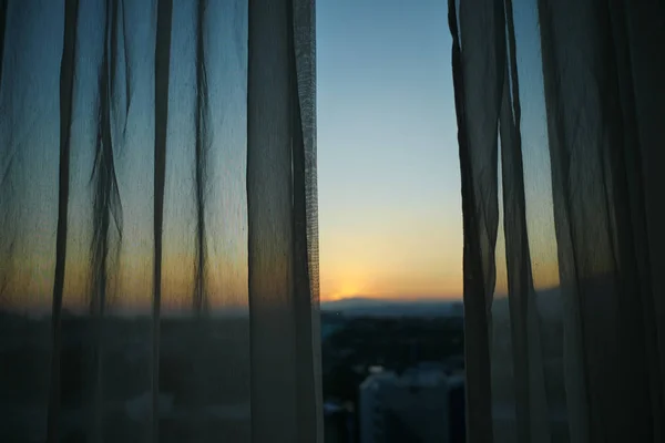 sunlight through white curtain with sunset sky view outside