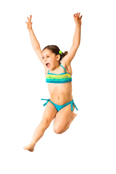小さな白人女性8歳の少女サイアン多色の水着で白い背景にジャンプします スポーツとレクリエーションの概念 — ストック写真