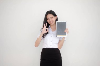 Portrait of thai adult student university uniform beautiful girl show her tablet.
