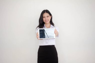 Portrait of thai adult student university uniform beautiful girl show her tablet.