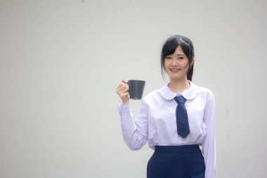 asia thai high school student uniform beautiful girl drinking hot drink