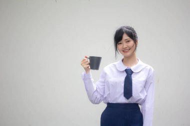 asia thai high school student uniform beautiful girl drinking hot drink