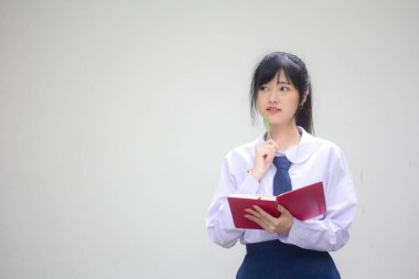 Asya Thai Lisesi üniformalı güzel kız. Bir kitap yaz.