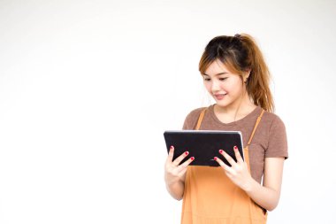 Beautiful young adult thai chinese bronze hair using her tablet.