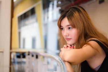 Beautiful young adult thai chinese bronze hair relax and smile