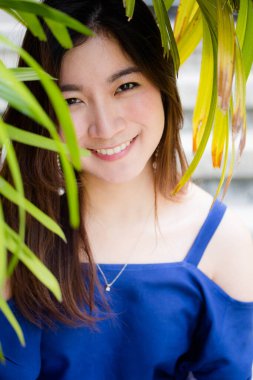 Beautiful young adult thai chinese blue tank top relax and smile