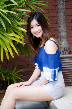 Beautiful young adult thai chinese blue tank top relax and smile