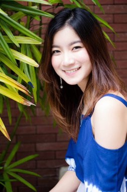 Beautiful young adult thai chinese blue tank top relax and smile