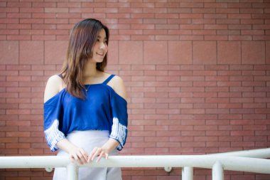Beautiful young adult thai chinese blue tank top relax and smile