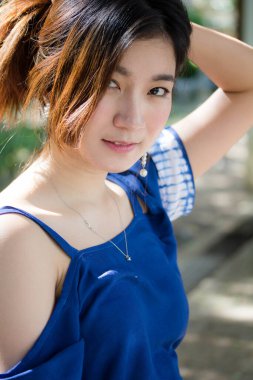 Beautiful young adult thai chinese blue tank top relax and smile