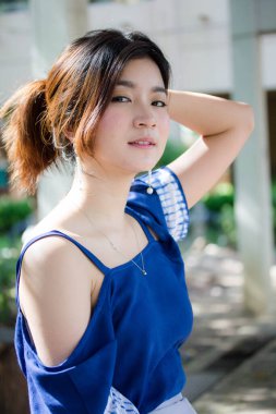 Beautiful young adult thai chinese blue tank top relax and smile