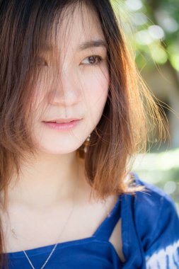 Beautiful young adult thai chinese blue tank top relax and smile