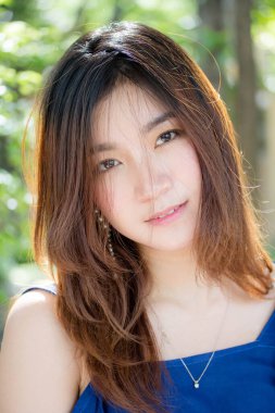 Beautiful young adult thai chinese blue tank top relax and smile