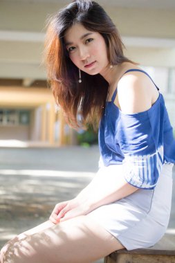 Beautiful young adult thai chinese blue tank top relax and smile