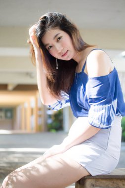 Beautiful young adult thai chinese blue tank top relax and smile