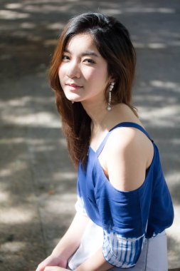 Beautiful young adult thai chinese blue tank top relax and smile