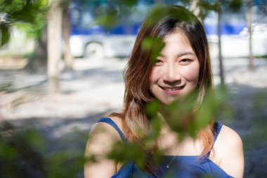 Beautiful young adult thai chinese blue tank top relax and smile