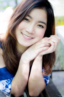 Beautiful young adult thai chinese blue tank top relax and smile