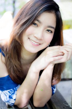 Beautiful young adult thai chinese blue tank top relax and smile