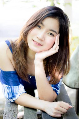 Beautiful young adult thai chinese blue tank top relax and smile