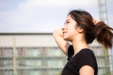 portrait of thai beautiful young adult, relaxed and smile in tennis court