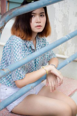 Portrait of thai adult beautiful girl short hair relax and smile