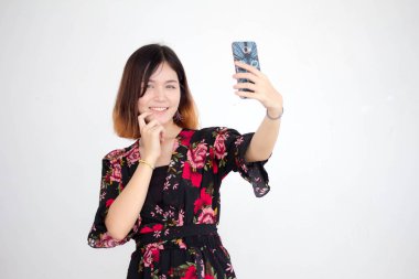 Portrait of thai adult beautiful girl short hair using her smart phone Selfie