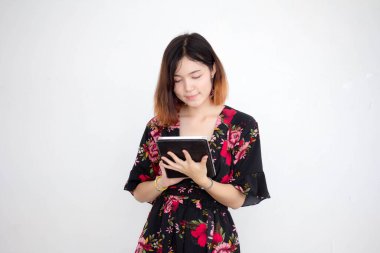 Portrait of thai adult beautiful girl short hair show her tablet.