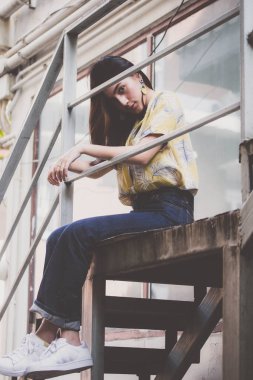 Portrait of thai yellow shirt adult beautiful girl relax time, in Vintage Style