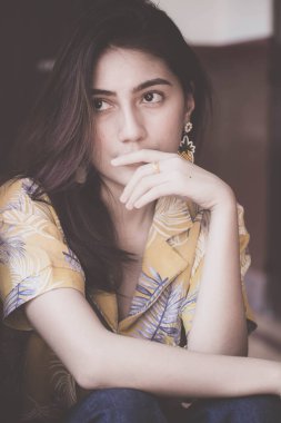 Portrait of thai yellow shirt adult beautiful girl relax time, in Vintage Style