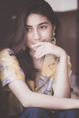 Portrait of thai yellow shirt adult beautiful girl relax time, in Vintage Style