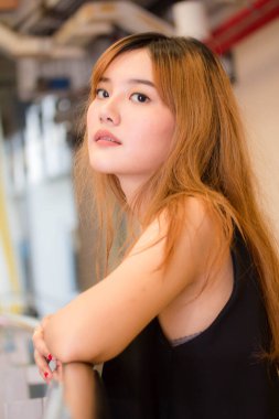 Beautiful young adult thai chinese bronze hair relax and smile