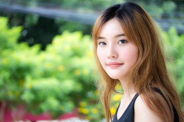 Beautiful young adult thai chinese bronze hair relax and smile